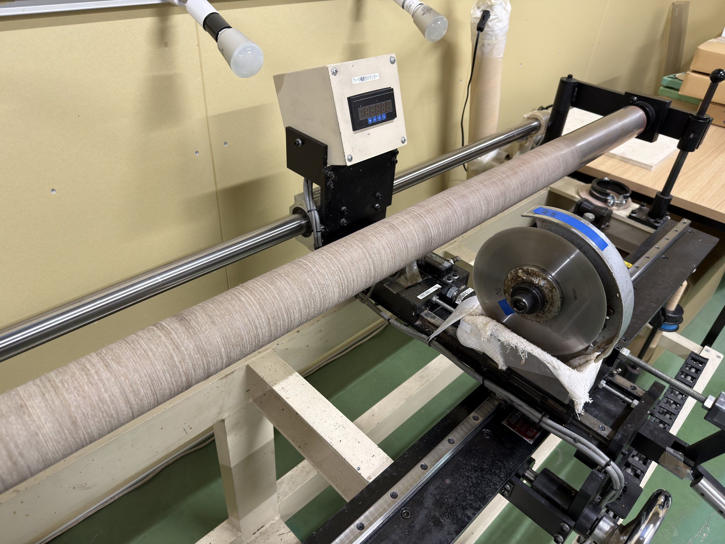 A blade slitting a roll to the specified width